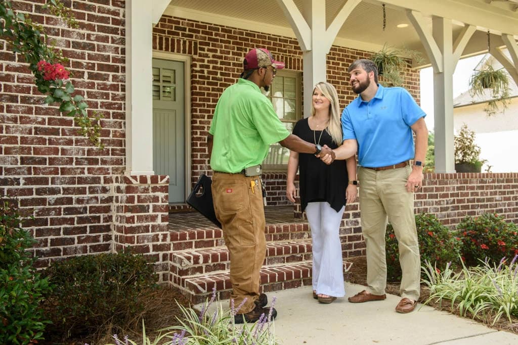 A Myers Comfort Specialists technician greeting homeowners
